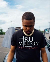 a man wearing a t - shirt that says tru million