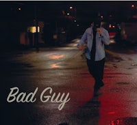 a man walking down a street with the words bad guy